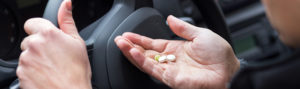 Woman taking pills in car