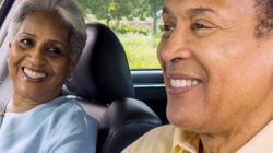 Older couple driving together in car